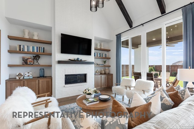 living room featuring built in features, high vaulted ceiling, a fireplace, beamed ceiling, and hardwood / wood-style flooring