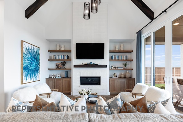 living room with beam ceiling, a wealth of natural light, and a fireplace