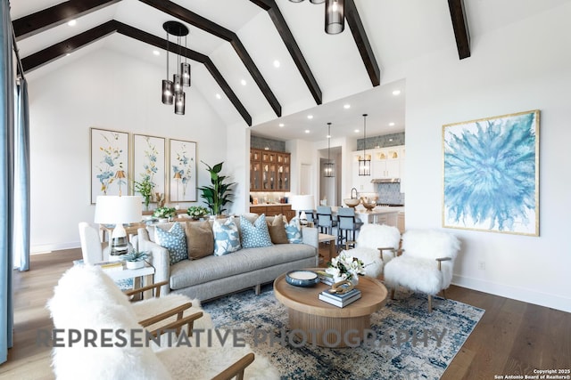 living room featuring beam ceiling, an inviting chandelier, hardwood / wood-style floors, and high vaulted ceiling