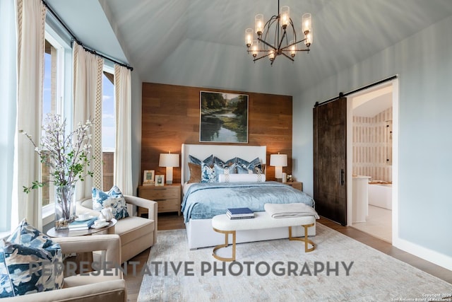 bedroom featuring vaulted ceiling, wooden walls, wood-type flooring, a barn door, and an inviting chandelier