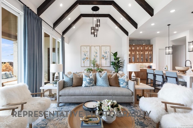 living room featuring a notable chandelier, beam ceiling, and high vaulted ceiling