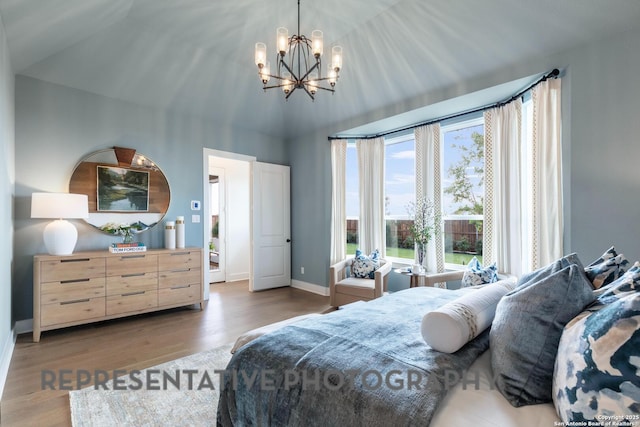 bedroom featuring hardwood / wood-style flooring and a chandelier