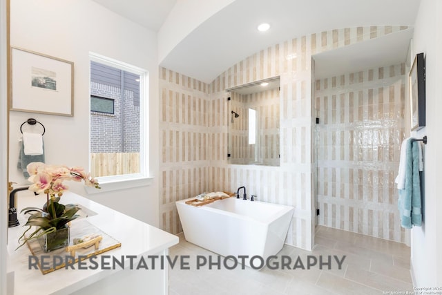 bathroom with tile patterned flooring and separate shower and tub