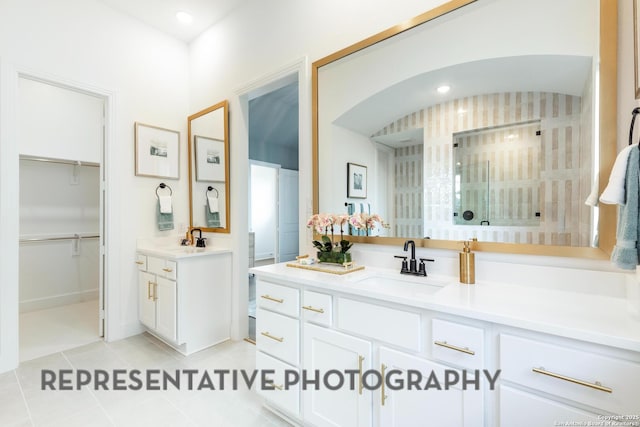 bathroom with tile patterned flooring, a shower, and vanity