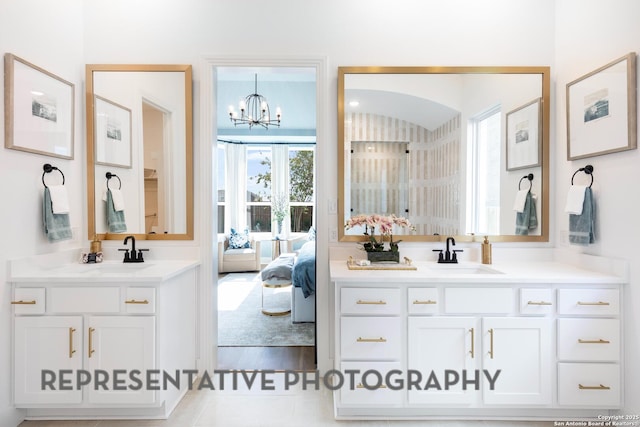 bathroom with vanity and an inviting chandelier