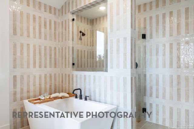 bathroom with sink and tile walls