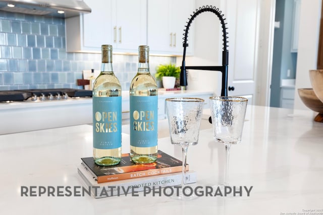 interior details with white cabinetry and backsplash