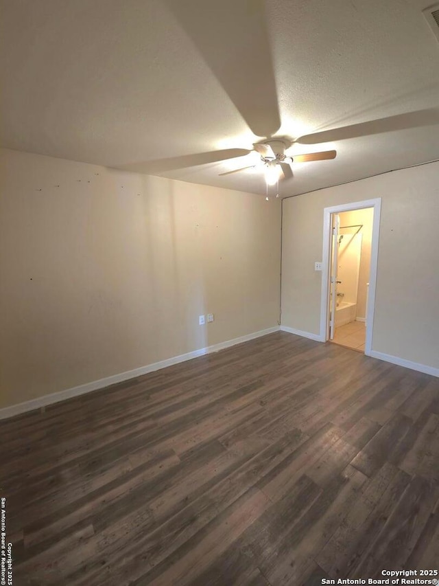 unfurnished room with ceiling fan and dark hardwood / wood-style flooring