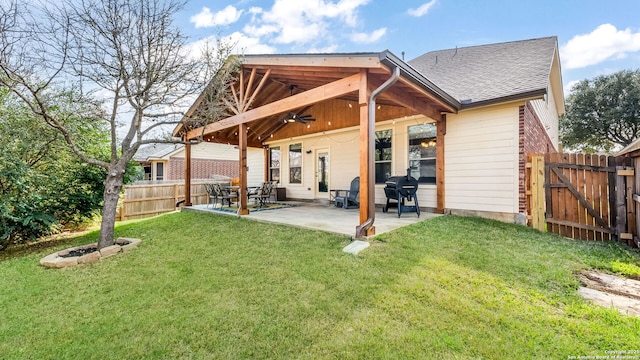 rear view of property with a patio area, ceiling fan, and a lawn