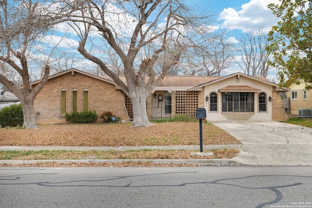 single story home featuring central air condition unit