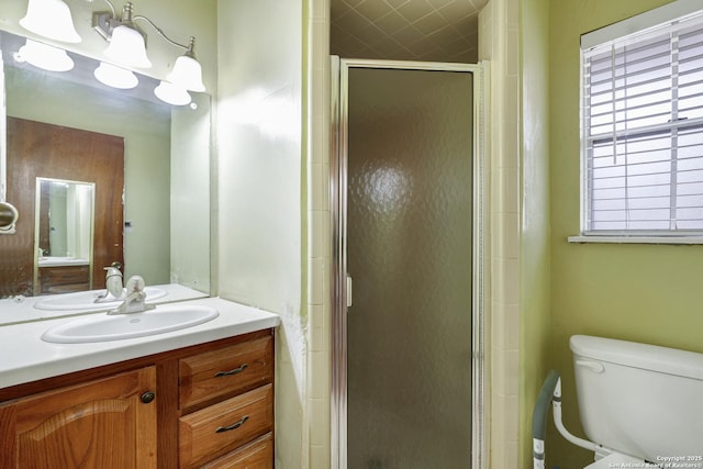 bathroom featuring an inviting chandelier, vanity, toilet, and an enclosed shower