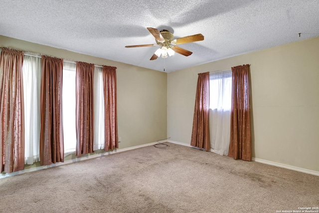 carpeted empty room with ceiling fan and a textured ceiling