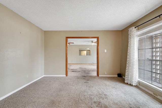 spare room with light colored carpet and a textured ceiling