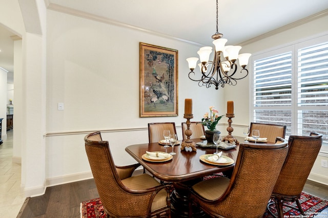 dining room with dark hardwood / wood-style flooring, crown molding, and a chandelier