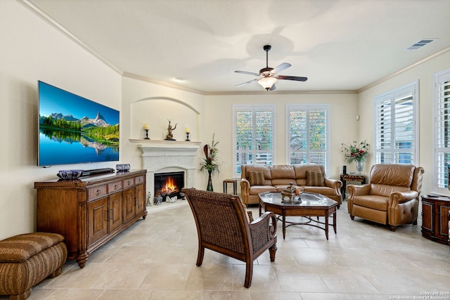 living room with ceiling fan and ornamental molding