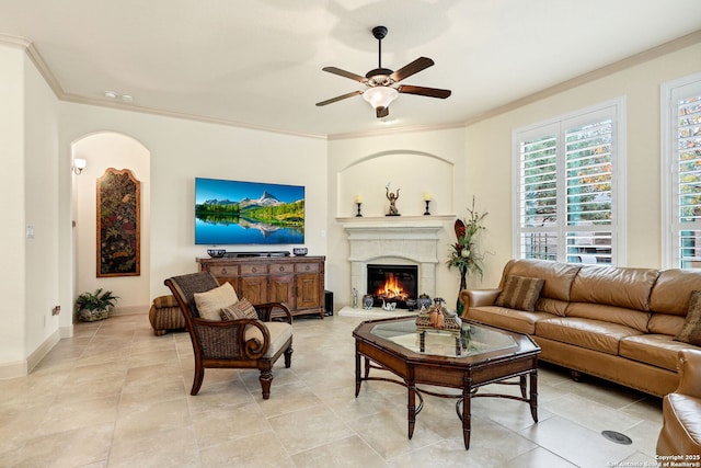 living room featuring crown molding and ceiling fan