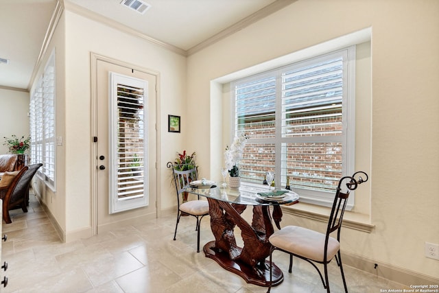 dining room featuring crown molding and a healthy amount of sunlight