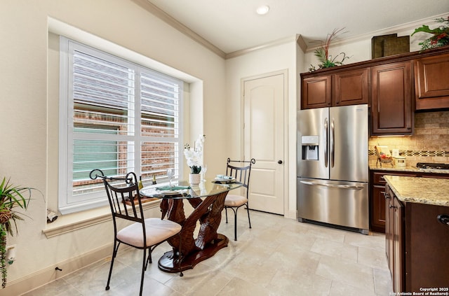 dining space featuring crown molding