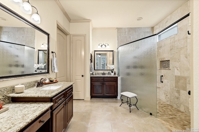 bathroom with crown molding, vanity, and a tile shower