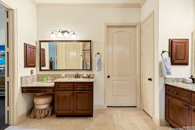 bathroom with vanity and ornamental molding