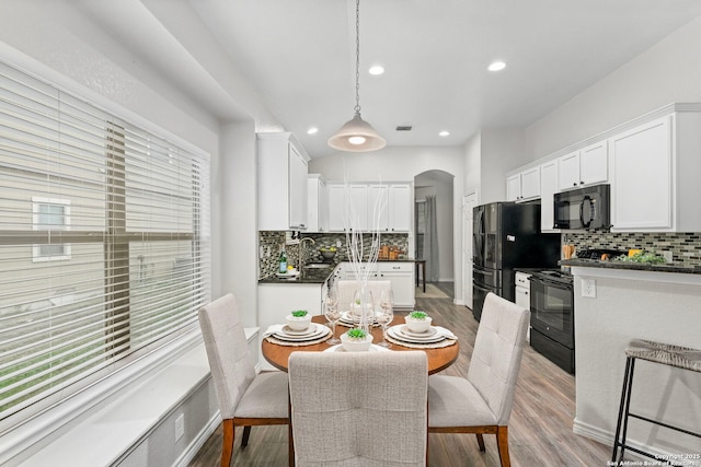 dining space with sink and light wood-type flooring