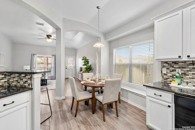 dining space with a textured ceiling, light hardwood / wood-style floors, beverage cooler, and ceiling fan