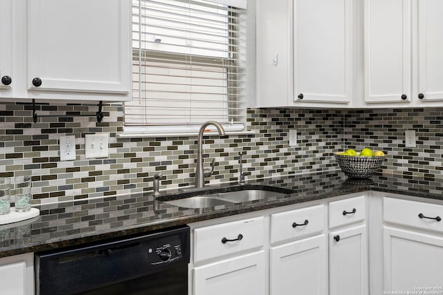 kitchen featuring dishwasher, sink, dark stone countertops, and white cabinets