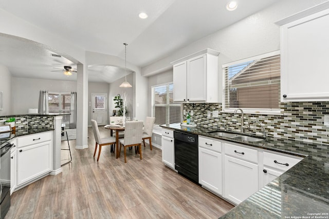 kitchen with pendant lighting, black dishwasher, dark stone countertops, sink, and white cabinets