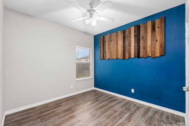 spare room featuring dark hardwood / wood-style floors and ceiling fan