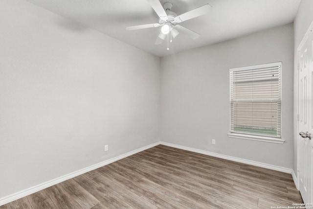 spare room featuring hardwood / wood-style flooring and ceiling fan