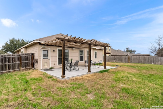 rear view of house featuring a patio, a pergola, and a lawn