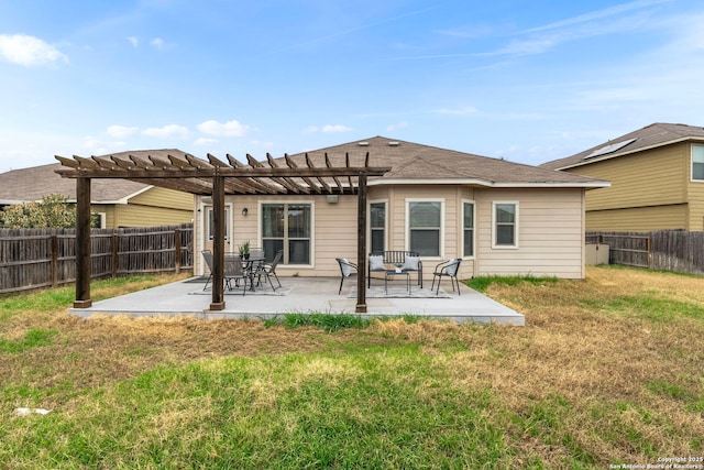 rear view of house with a patio, a pergola, and a lawn