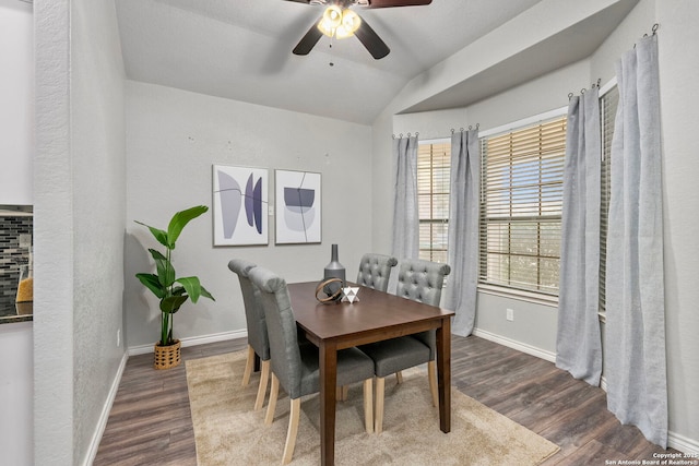 dining area featuring wood-type flooring, vaulted ceiling, and ceiling fan