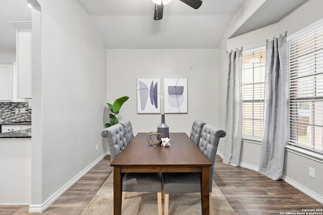 dining room with hardwood / wood-style flooring, ceiling fan, lofted ceiling, and a wealth of natural light