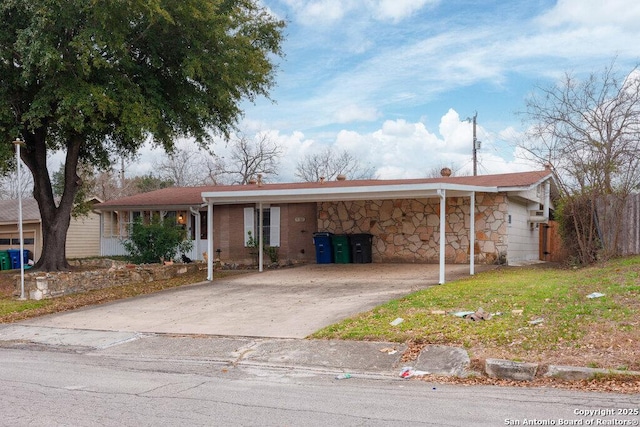 ranch-style house featuring a carport and a front lawn