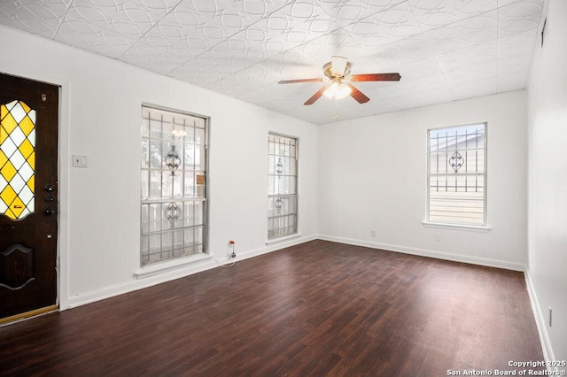 foyer entrance featuring dark wood-type flooring and ceiling fan