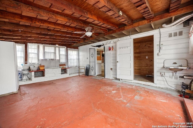 miscellaneous room featuring concrete flooring and ceiling fan