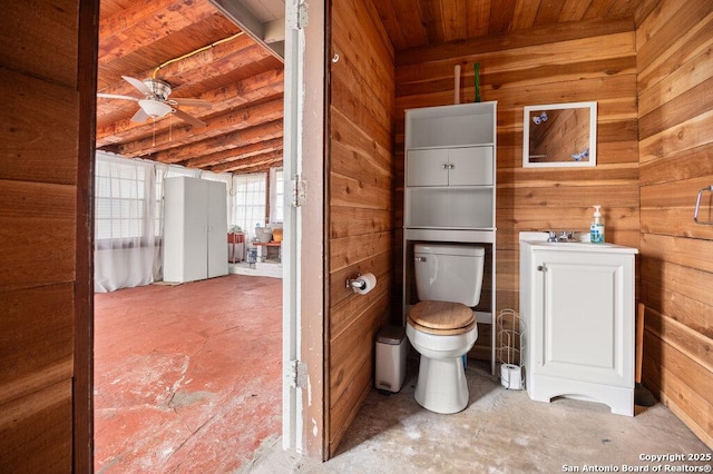 bathroom with toilet, wooden walls, concrete flooring, and wooden ceiling