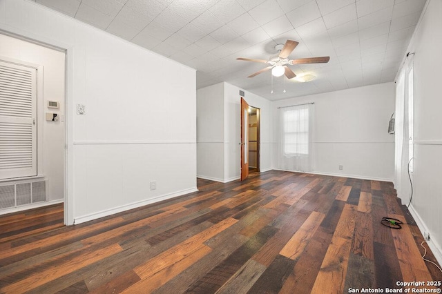 unfurnished room with ceiling fan and dark hardwood / wood-style floors