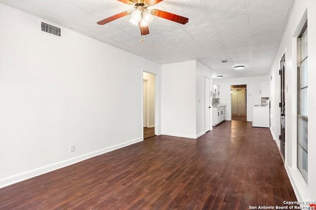 unfurnished living room with washer / dryer, dark hardwood / wood-style floors, and ceiling fan