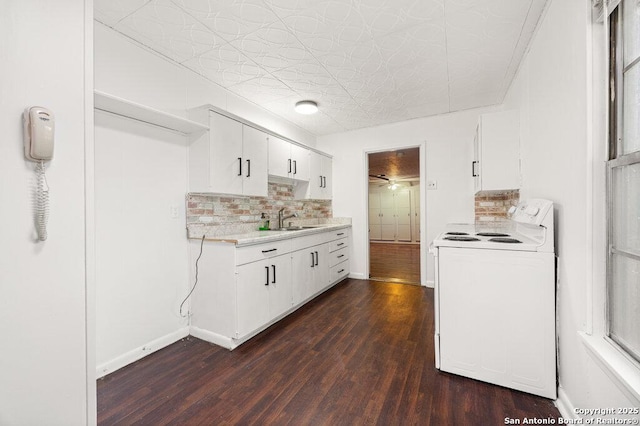 kitchen with sink, white electric range, white cabinets, dark hardwood / wood-style flooring, and decorative backsplash