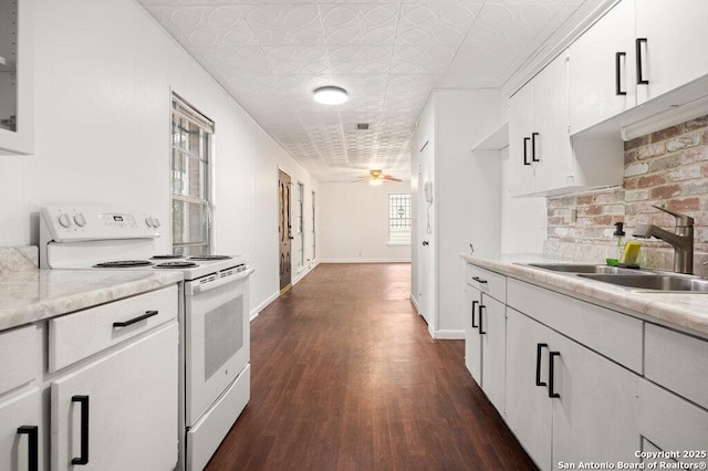 kitchen featuring white cabinetry, sink, white electric range, and decorative backsplash