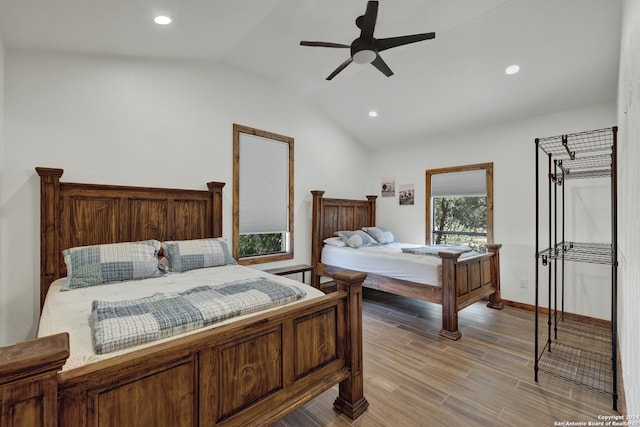 bedroom with vaulted ceiling, light hardwood / wood-style floors, and ceiling fan