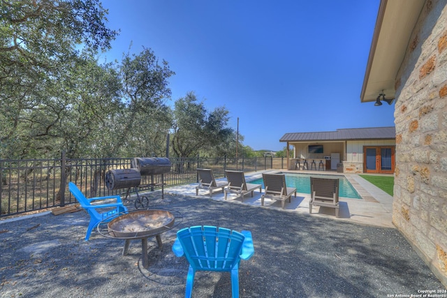 view of swimming pool featuring a patio area and an outdoor fire pit