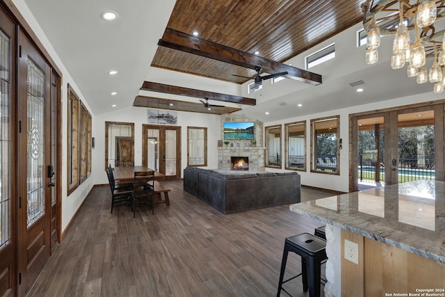 living room with ceiling fan, vaulted ceiling with beams, dark hardwood / wood-style flooring, and french doors