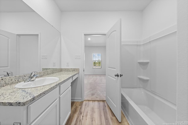 bathroom featuring shower / tub combination, vanity, and hardwood / wood-style floors