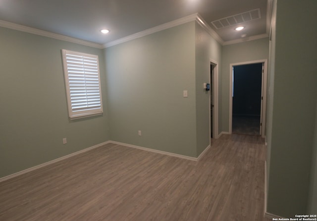 unfurnished room featuring crown molding and dark wood-type flooring