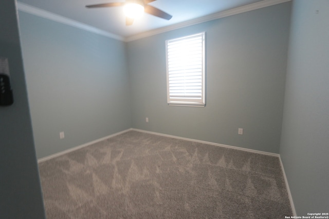 empty room featuring crown molding, carpet flooring, and ceiling fan