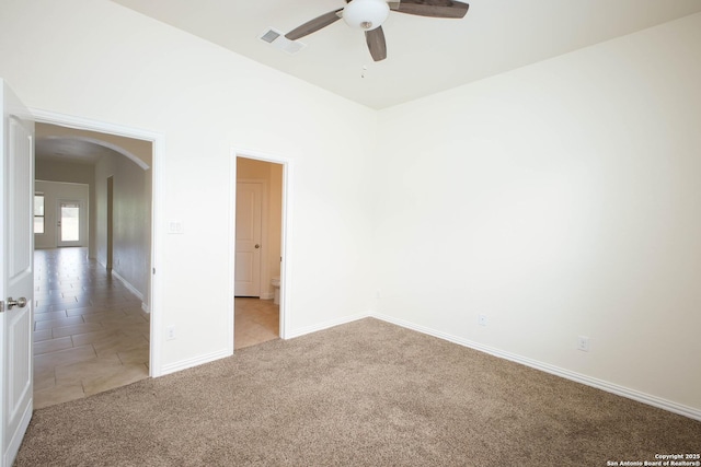 carpeted spare room with ceiling fan