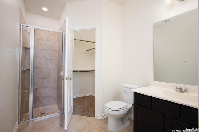 bathroom featuring vanity, an enclosed shower, tile patterned floors, and toilet